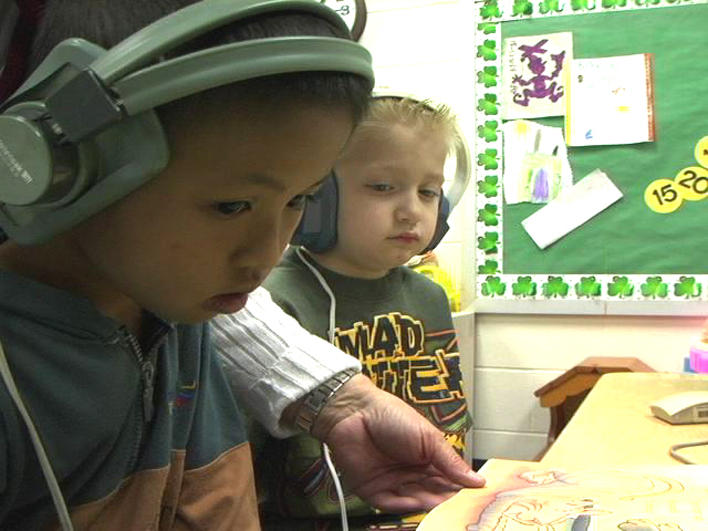 Boy from Burma learning to read at school