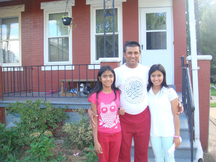 Burmese family in front of their home