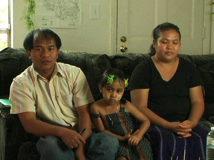 Family from Burma on couch at home