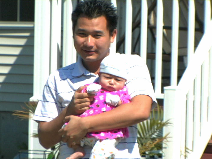 Man and baby waving goodbye to wife (and mother)