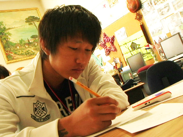 Man from Burma doing work during ESL class