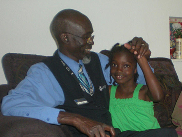 Darfuri man and daughter in their living room