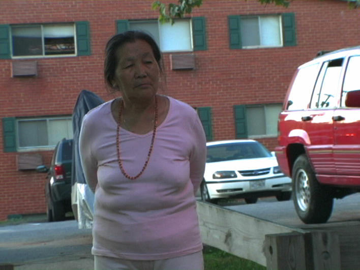 Standing in the parking lot of her apartment complex