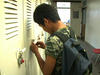 Boy from Burma opening his school locker